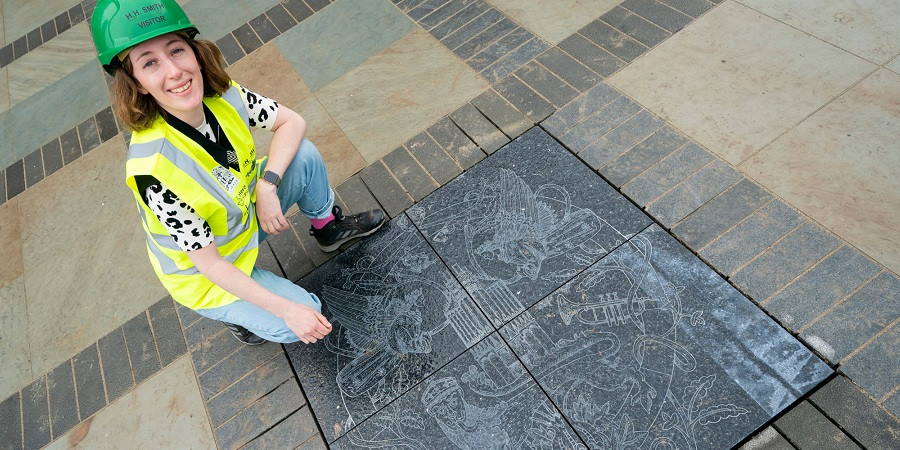 Artist with paving stone.