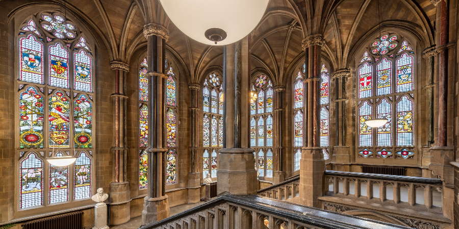 Staircase underneath stained glass windows.