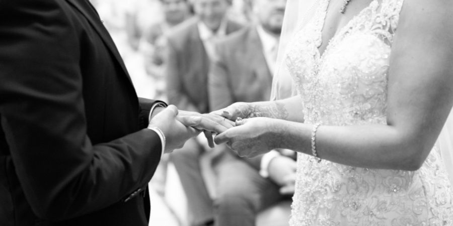 A couple holding hands on their wedding day.