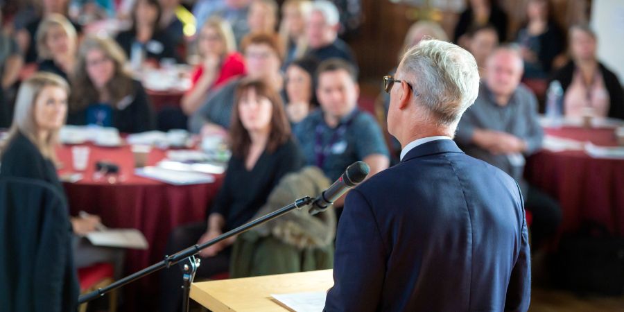 A man speaking to a crowd.