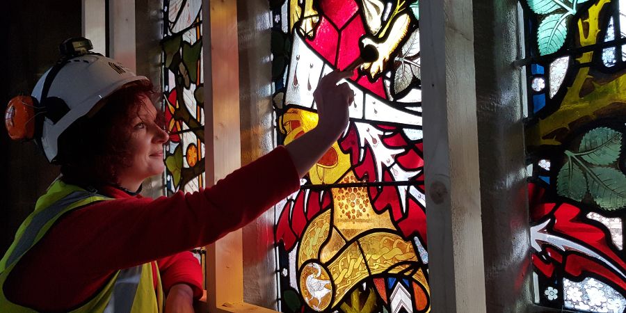 Somebody working on the restoration of the stained glass at Rochdale Town Hall.