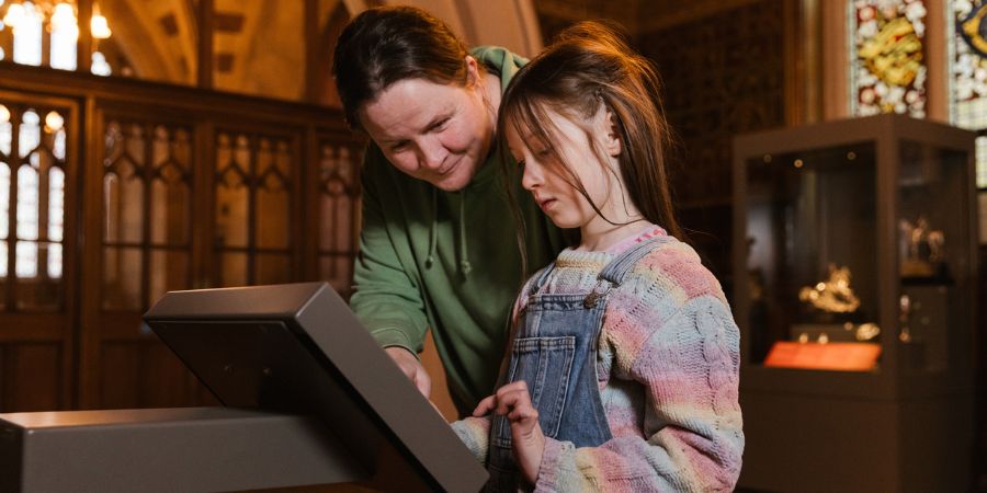 An adult and child in the Small Exchange at Rochdale Town Hall.