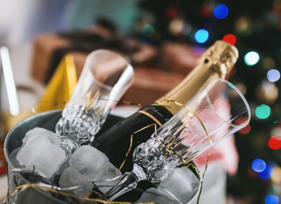 A bottle of champagne in an ice bucket.